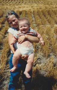 This is me in the middle of a wheat field, hoisting my little brother up for a photo