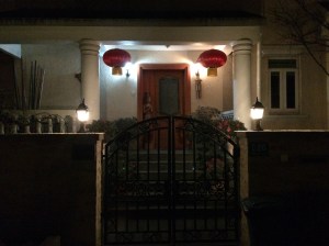 Folks hang red lanterns near their doorways and place greeting signs and paper cut-out flowers on windows and entryways.